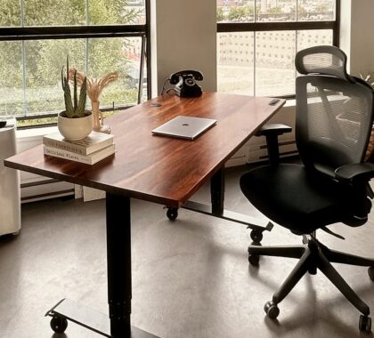 a desk with a laptop on it in an office