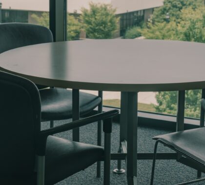 a table and chairs in front of a large window